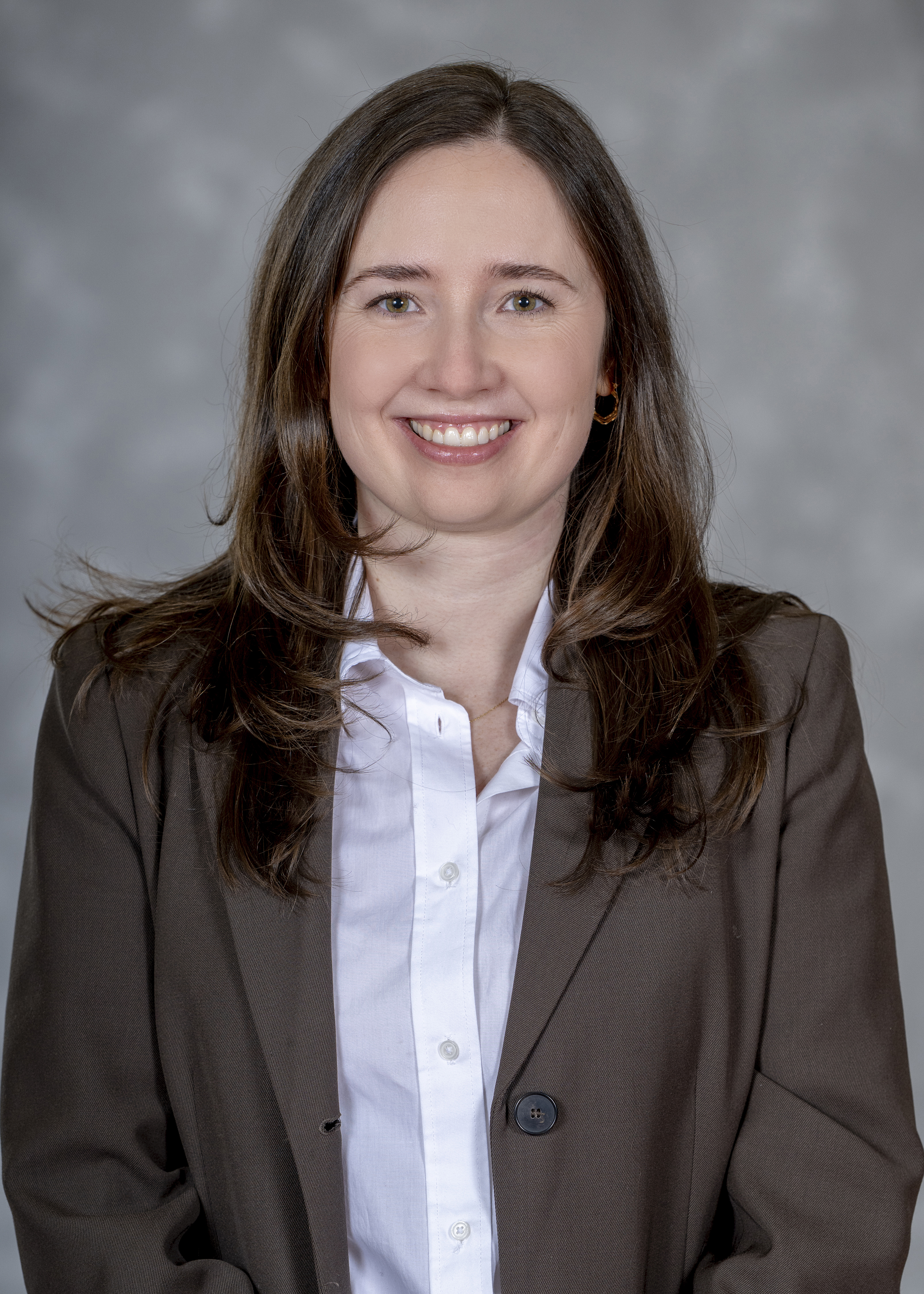 Lauren, instructional designer, smiling and wearing a brown blazer